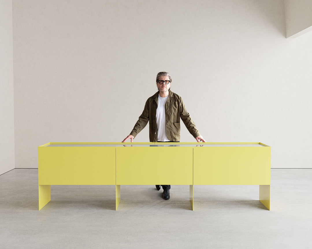 Custom Bora Metal Credenza Cabinet & Portrait Founder Standing behind.