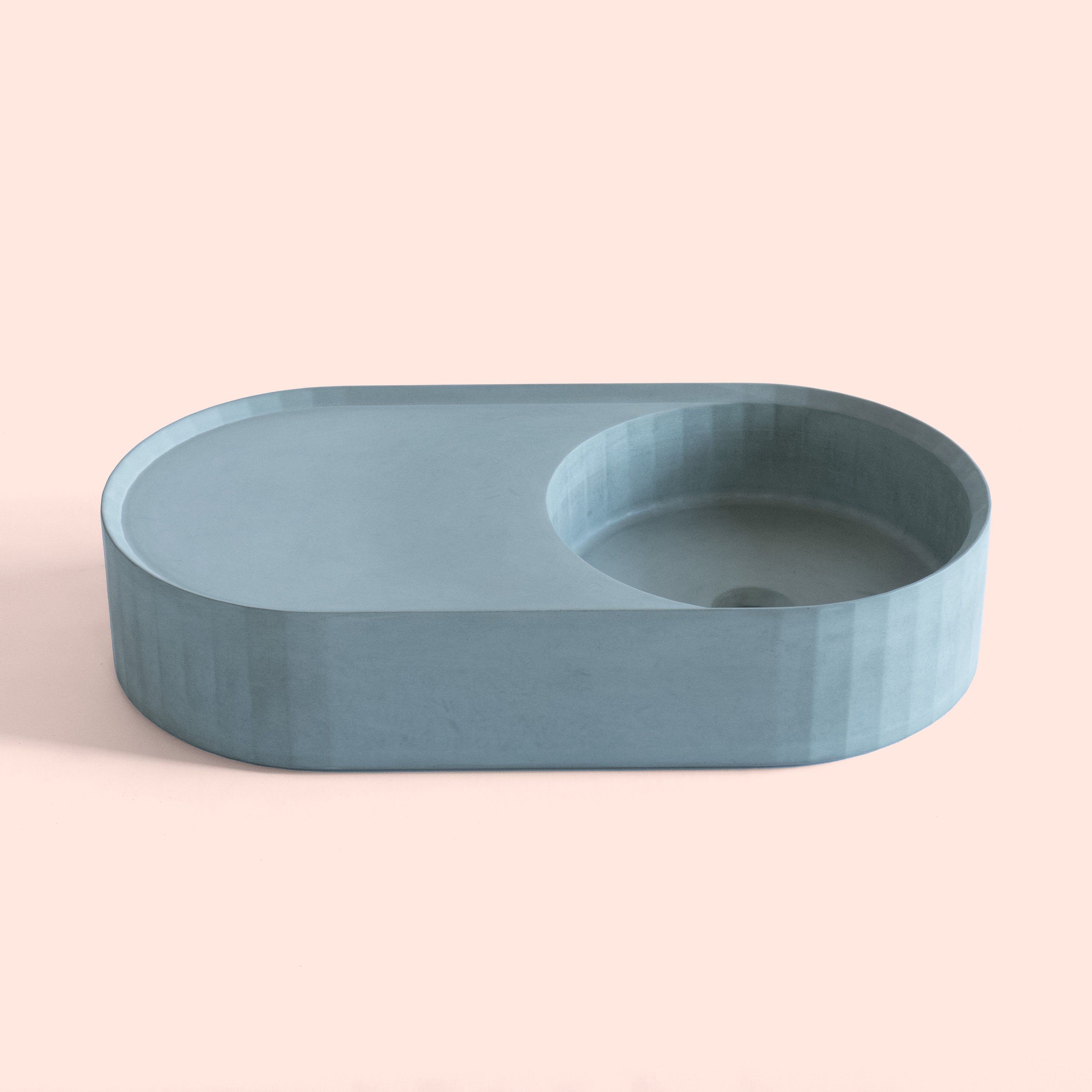 Facet Pill concrete vanity basin with faceted form and symmetrical vanity shelf