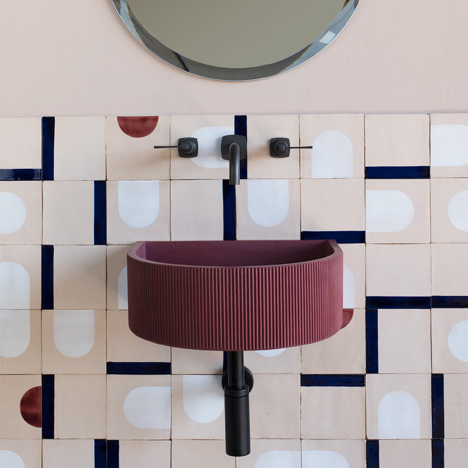 Kiri ribbed concrete bathroom basin with vertical ridges and curved bowl